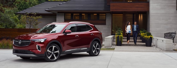 Red Buick Envision Avenir parked Infront of the beautiful house